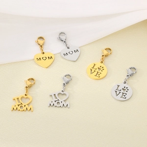 Detailed close-up of heart and round MOM pendants in gold and silver stainless steel