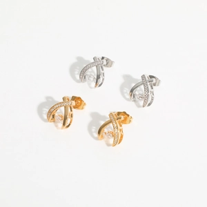 Crossed fishtail stud earrings with inlaid cubic zirconia in silver and gold colors