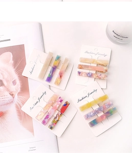 Detailed view of colorful acetate hair clips with marble textures on display cards