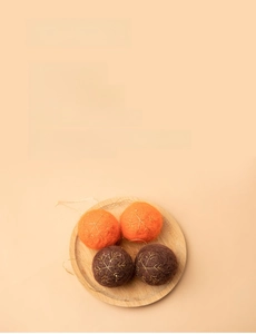 Detail of plush orange and brown Christmas balls with gold embroidered snowflakes