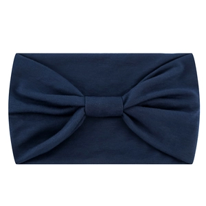 Detailed texture of dark blue elastic yoga headband fabric showing fine knit stitch