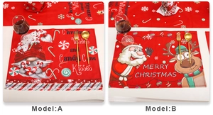 Detail der Weihnachts-Platzsets mit Zwergen- und Weihnachtsmann-Druck und weißer Naht