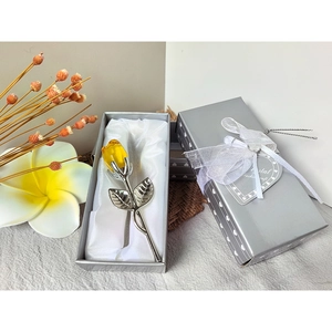 Detailed view of a yellow crystal rose gift set in an elegant silver box with satin lining