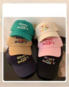 Detail of diverse colors and 3D embroidered text on cotton twill baseball caps