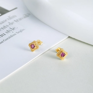 Detailed close-up of S925 silver gold-plated stud earrings with red zircon in retro frame