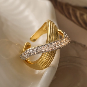 Minimalist gold two-tone criss-cross open ring featuring pavé cubic zirconia and ribbed design