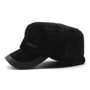 Detail of plush faux mink fur texture and leather brim on winter flat top thermal cap