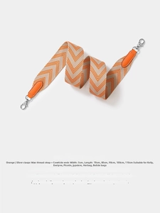 Detail of orange and beige woven herringbone shoulder strap with silver swivel hooks