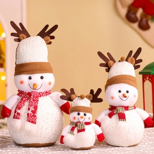 Detailed view of three plush Christmas snowmen in various sizes with festive knits