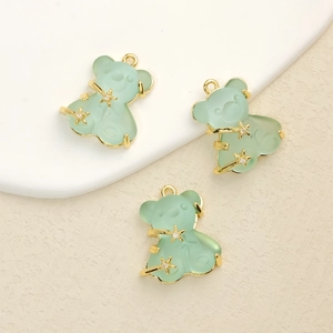 Detailed view of light green resin bear pendants with gold plating and zircon inlay