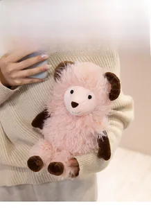 Close-up of pink fluffy lamb plush toy being held by hands to show soft plush texture