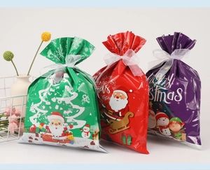 Three-color Christmas drawstring gift bags with cartoon Santa and reindeer patterns