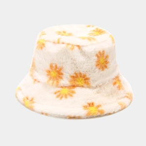 Detailed close-up of fluffy faux rabbit fur bucket hat with orange daisy patterns
