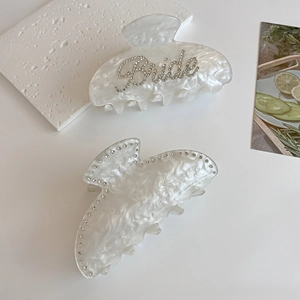 Pearlescent white acetate claw clips with rhinestones and Bride lettering for hair