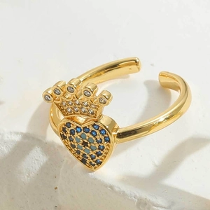 Macro view of gold-plated crown heart ring featuring blue and white pavé zircon stones