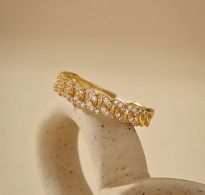 Close-up of a gold-plated Cuban chain link ring featuring sparkling cubic zirconia stones