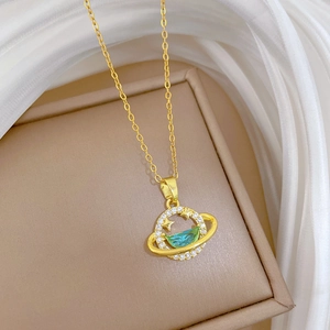 Gold star galaxy zircon necklace with planet pendant on a soft champagne jewelry box