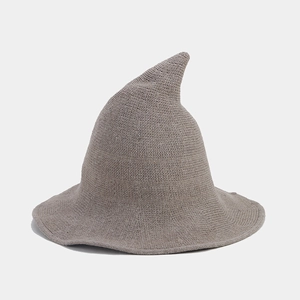 Detailed close-up of taupe knitted witch hat with wide brim and pointed top crown