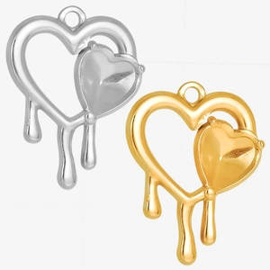 Close-up of gold and silver heart charms with unique melting design for jewelry DIY