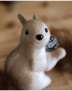 Macro shot of foam squirrel ornament with realistic flocking texture for holiday decor