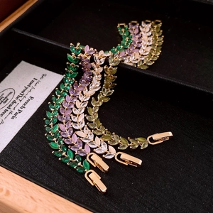 Detail of colorful marquise cut zircon leaf bracelets with secure fold-over clasps