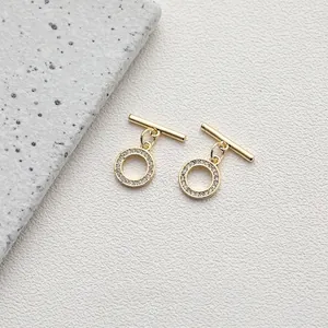 Detailed macro view of a 14K gold plated OT toggle clasp set with shimmering zircon stones