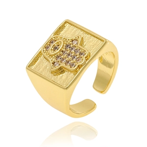 Detail of gold square ring with Hamsa Hand and sparkling rhinestones on white background