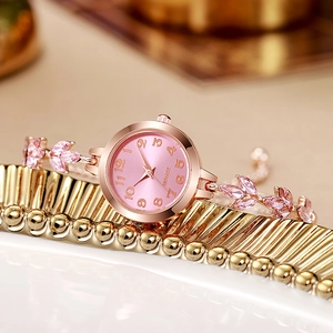 Elegant rose gold women's watch with pink dial and clover leaf bracelet on gold plate