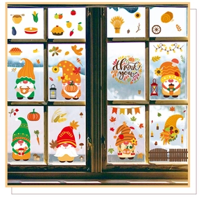 Close-up of Thanksgiving window stickers with cute gnomes and pumpkins on a glass pane