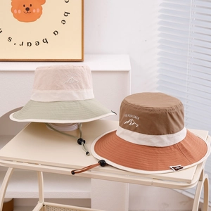 Detail of embroidered outdoor sun hats with adjustable windproof chin straps for kids