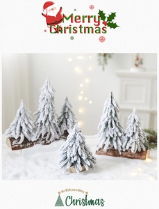 Detailed view of mini snow-covered Christmas trees with rustic natural wooden bases