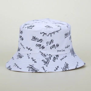 Detail view of the white canvas bucket hat featuring black graffiti style letter embroidery