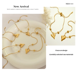 Macro detail of gold-plated heart pendant bracelet with adjustable slider clasp
