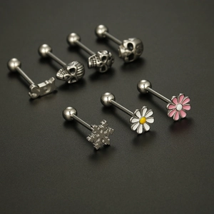 Gothic stainless steel tongue rings featuring skulls and daisies on a black background