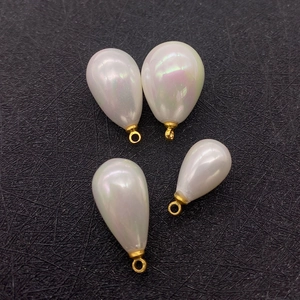 Set of four iridescent white teardrop pearl pendants with gold metal loops for DIY jewelry