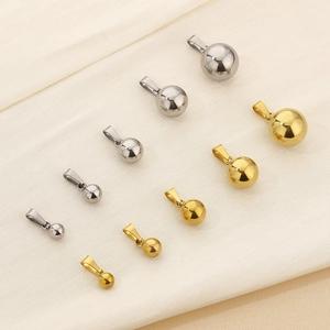 Polished stainless steel ball pendants in various sizes and finishes on fabric