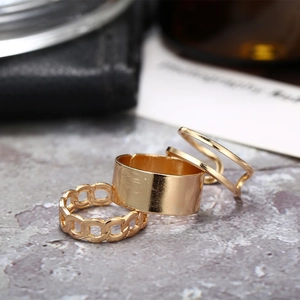Three-piece gold plated ring set featuring wide band and hollow chain on textured stone