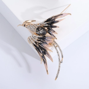 Detail of elegant phoenix brooch with gold plating, colorful enamel and sparkling crystals