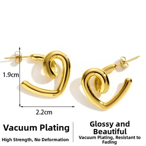 Detailed view of gold twisted heart earrings measuring 1.9cm by 2.2cm in dimensions