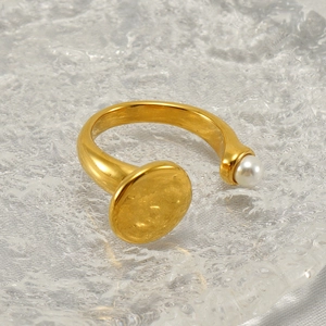 Fashionable gold plated stainless steel ring featuring a white pearl and metallic disc