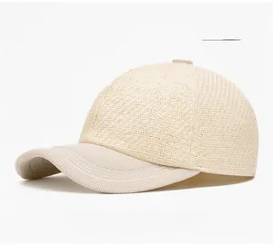 Detail of beige straw woven baseball cap showing breathable mesh texture and fabric brim