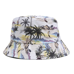 Macro detail of white reversible bucket hat with tropical beach and palm tree prints