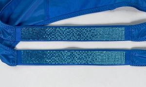 Macro detail of deep blue fitness thong straps featuring double rows of blue rhinestones