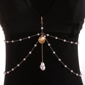Detail of gold body chain with pearls, seashell pendant and dangling baroque pearl