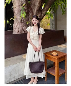 Close-up of a large dark handmade woven leather tote bag with an elegant texture