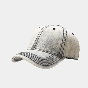 Detail shot of vintage washed denim baseball cap with contrast stitching and industrial style