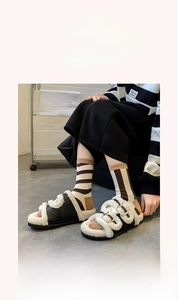Detail of classic striped cotton socks paired with plush slippers in a lifestyle setting