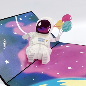 Detailed 3D pop-up astronaut with colorful planet balloons on space themed greeting card