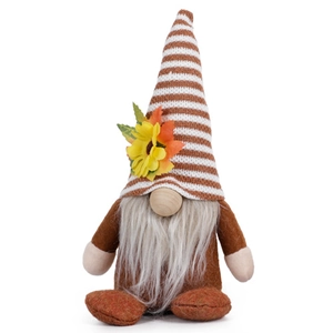Close-up of harvest gnome with striped hat, sunflower and maple leaf decorations
