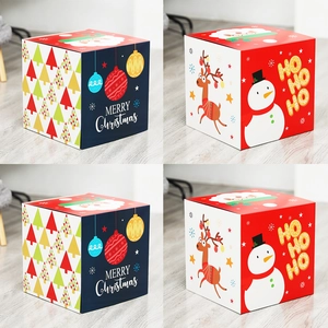 Detail of Christmas gift boxes with Santa and reindeer patterns on wooden floor